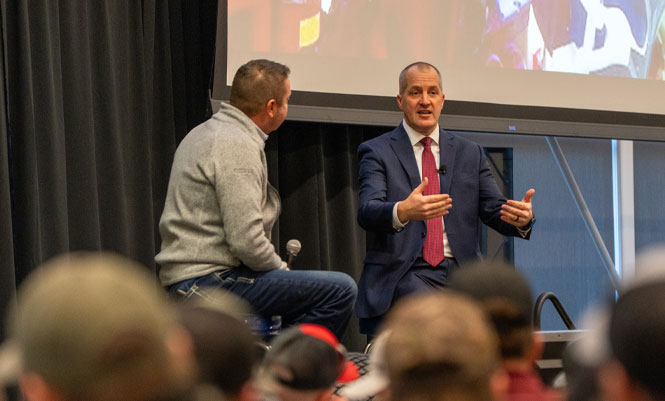 Iowa Secretary of Agriculture, Mike Naig, shares the stage with Scott Sloan at the 2025 Titan University Summit.